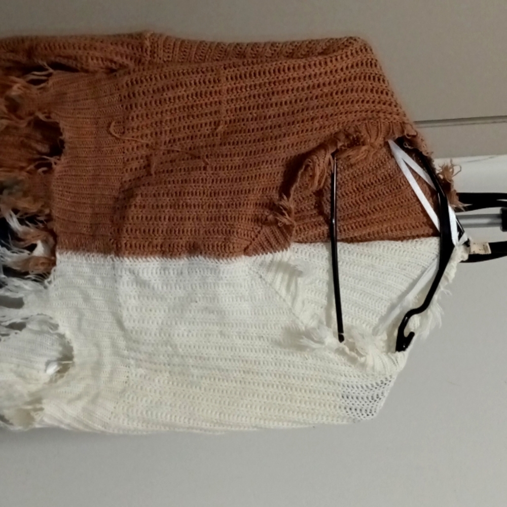 It's a medium/small, brown and white cover up.